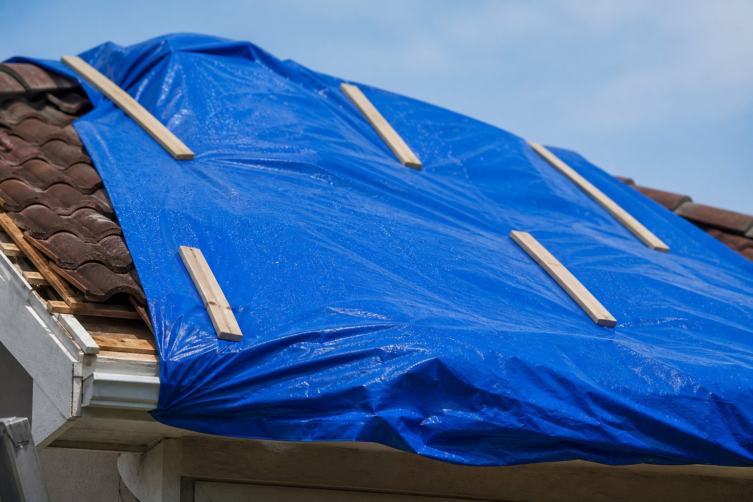Emergency tarping protecting residential roof