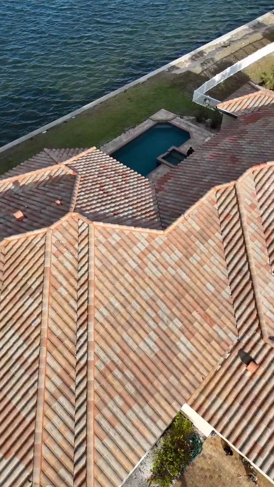 Finished variegated tile roof replacement pool and canal home SWFL