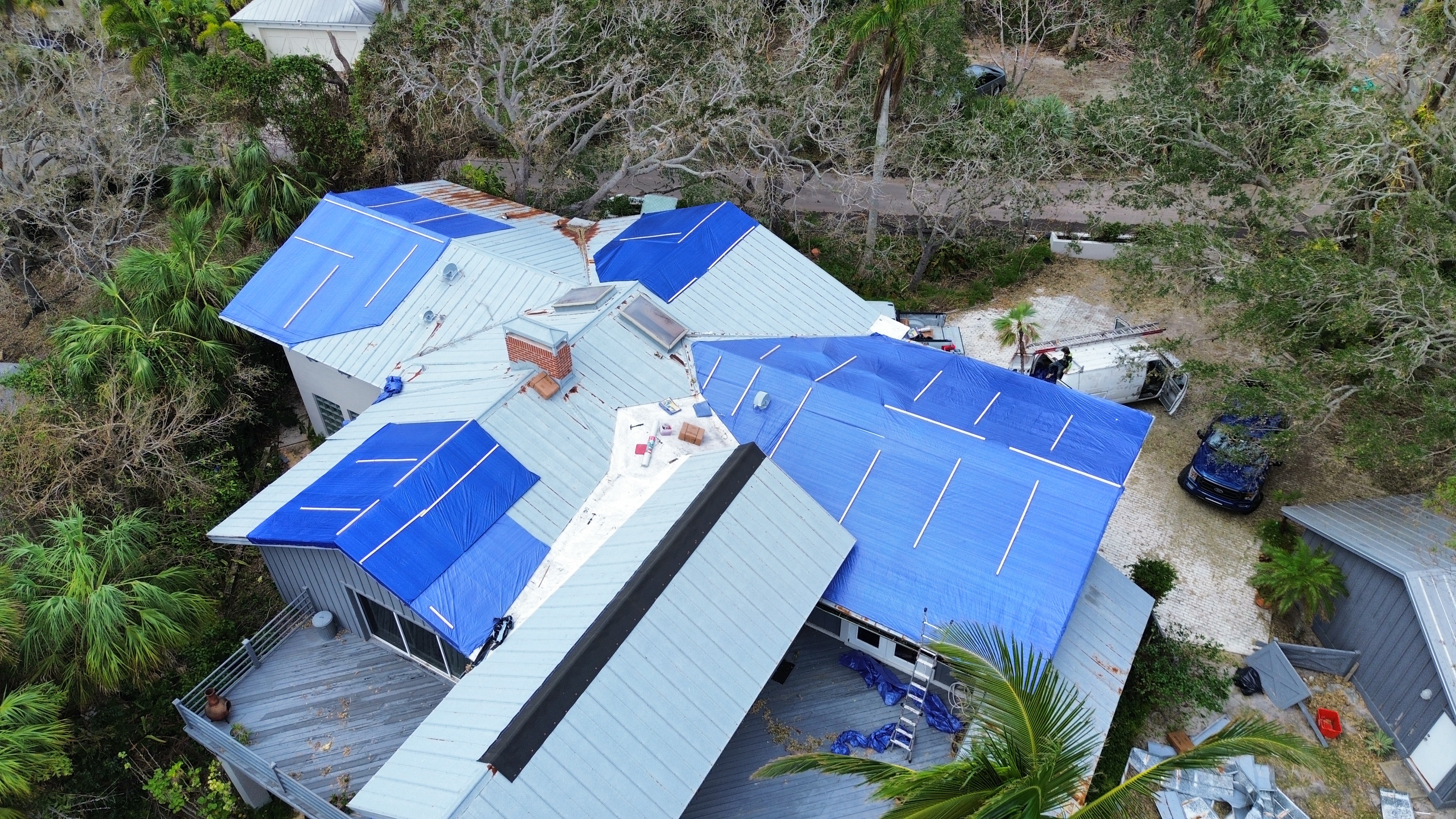 Emergency tarp on metal roof after Florida storm — Horizon Roofing
