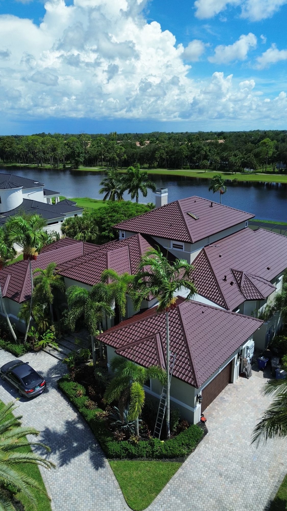 Finished Worthouse Dura steel tile roof in burgundy on a Cape Coral canal home